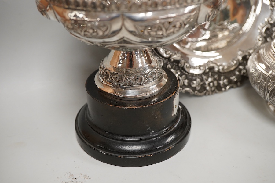Two Indian white metal rose bowls, one octagonal with stand, diameter 12.5cm, together with a small white metal stand, with foliate border.